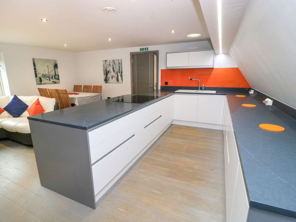 A kitchen with a modern design and dining area at Silver Copse in Frilford Heath Near Abingdon