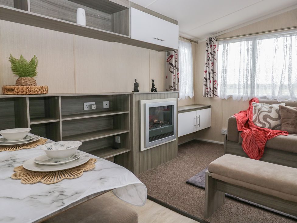 A living room with a sofa and a dining table at Heathfield Park S4