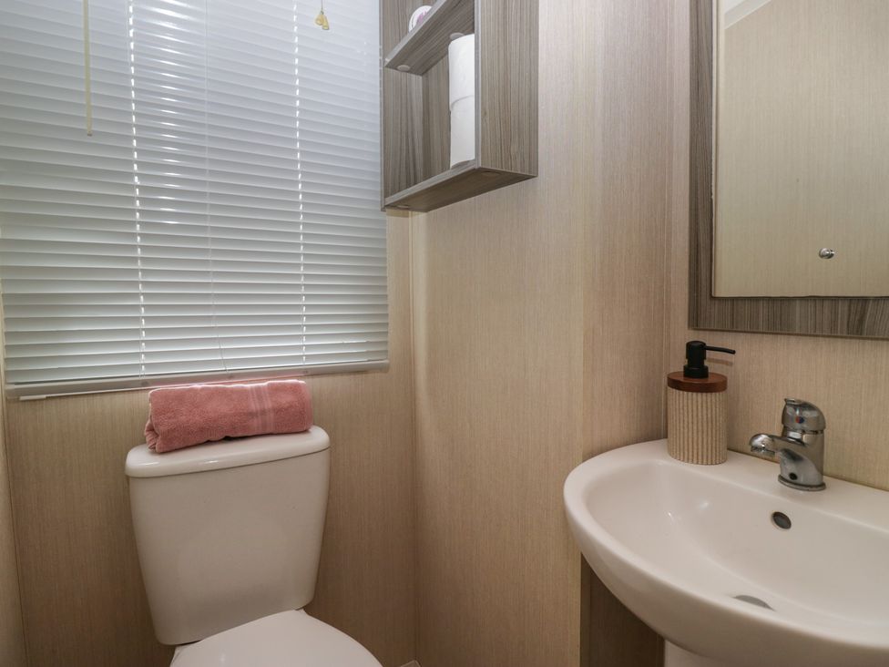 A bathroom with a toilet and sink at Heathfield Park S4