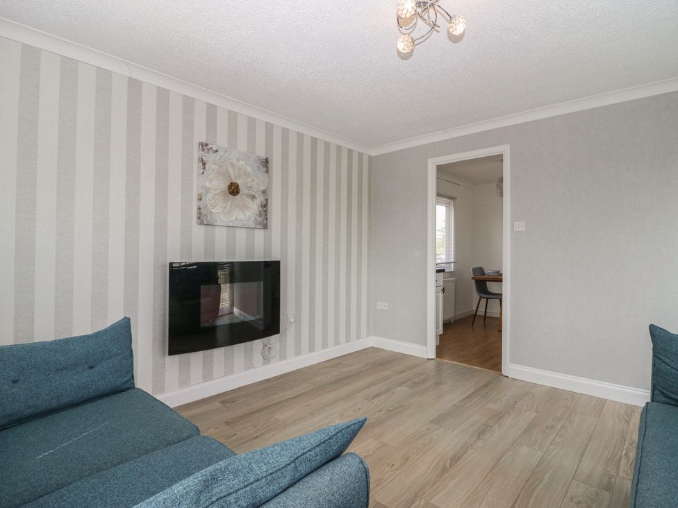 A living room with a television and sofa at Cherry Tree in Kidlington