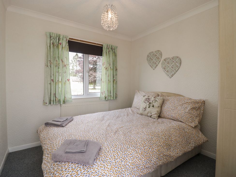 A bedroom with a bed and window at Cherry Tree in Kidlington