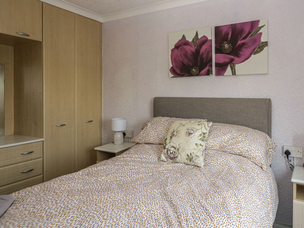A bedroom with a bed, bedside table and wardrobe at Cherry Tree in Kidlington