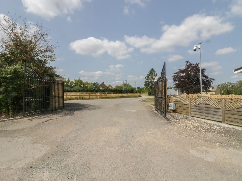 An entrance with gates and trees at Cherry Tree in Kidlington