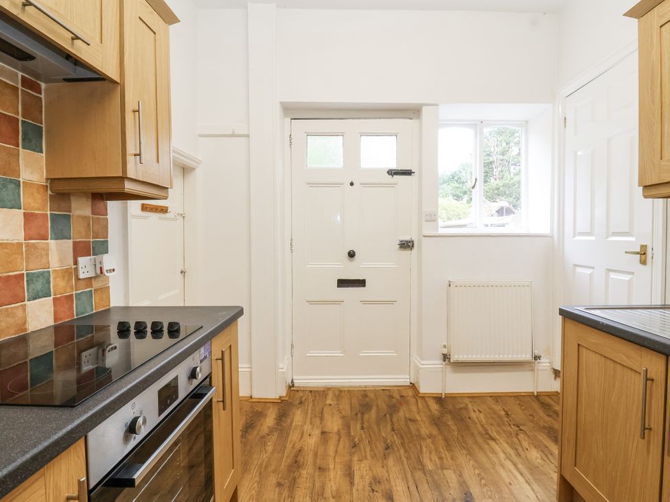 A kitchen featuring a front door and an oven at The Cottage in Clevedon