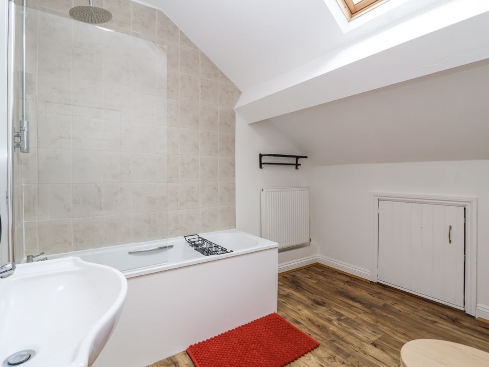 A bathroom with a bathtub and shower at The Cottage in Clevedon