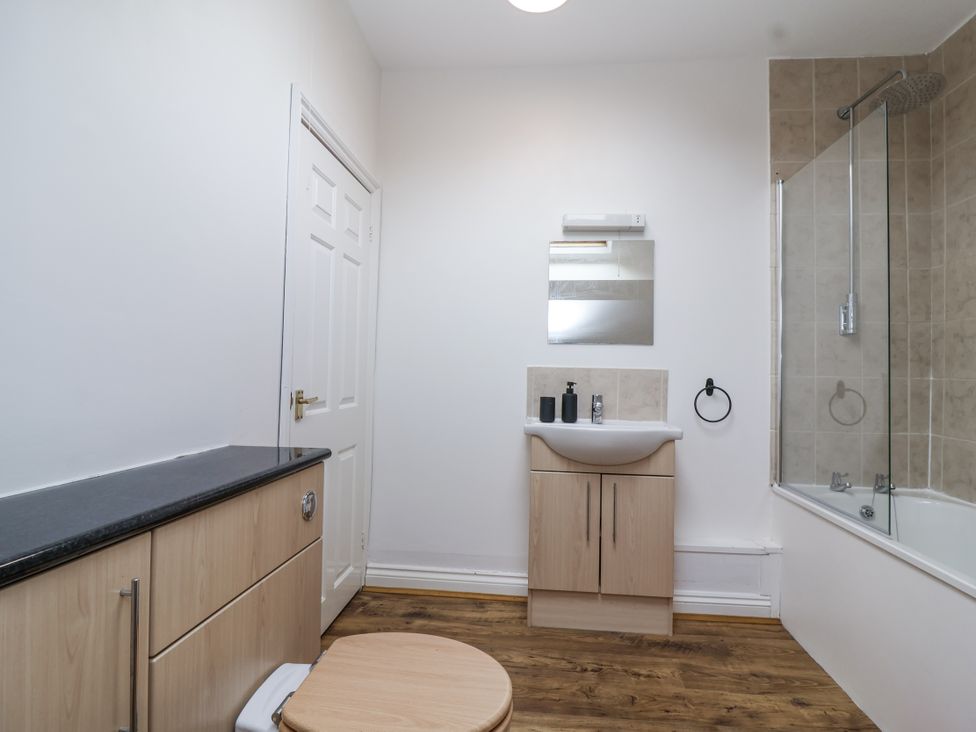A bathroom with a toilet, sink, and bathtub at The Cottage in Clevedon