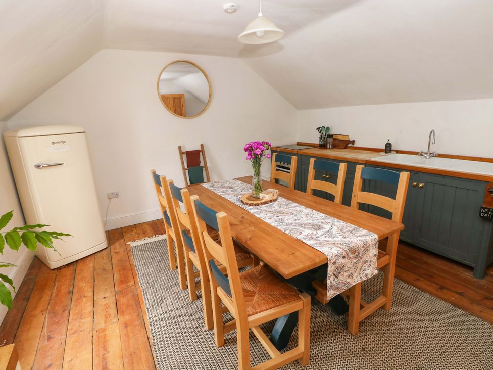 A dining room with a table and chairs at 18 Main Street 