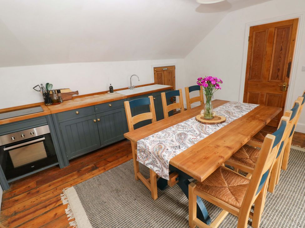 A kitchen with a dining table and chairs at 18 Main Street