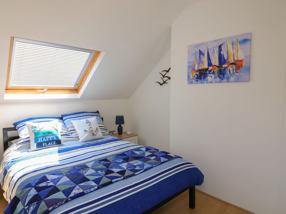 A bedroom with a bed and window at The Hideaway