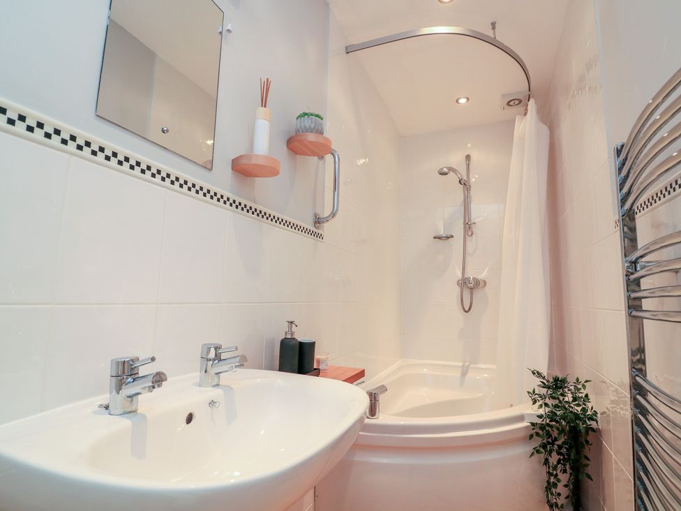 A bathroom with a sink and shower at The Hideaway in 
