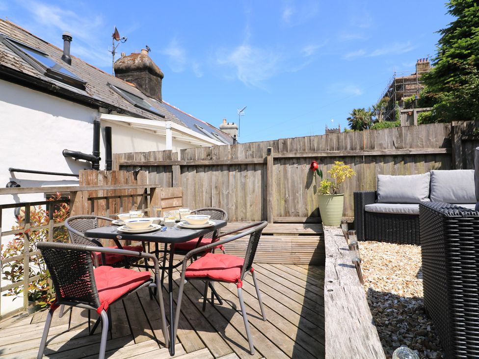 An outdoor seating area with a table and chairs at The Hideaway in 