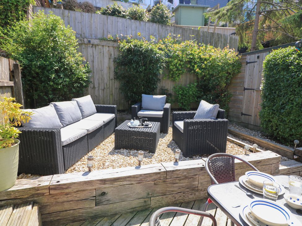 An outdoor seating area with a sofa and chairs at The Hideaway in 