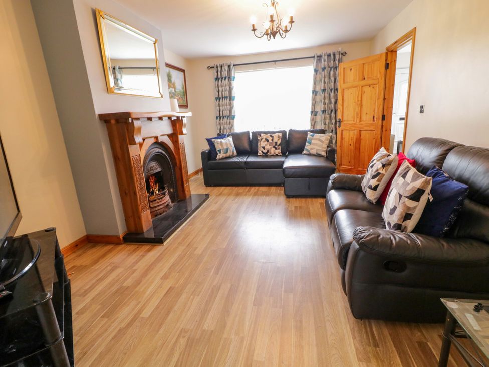 A living room with a sofa and fireplace at 7 Killybrack Glen in Omagh