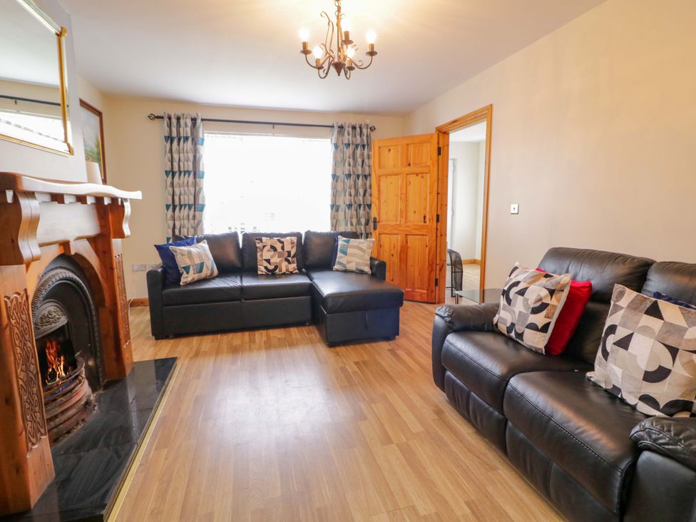 A living room with a sofa and fireplace at 7 Killybrack Glen in Omagh