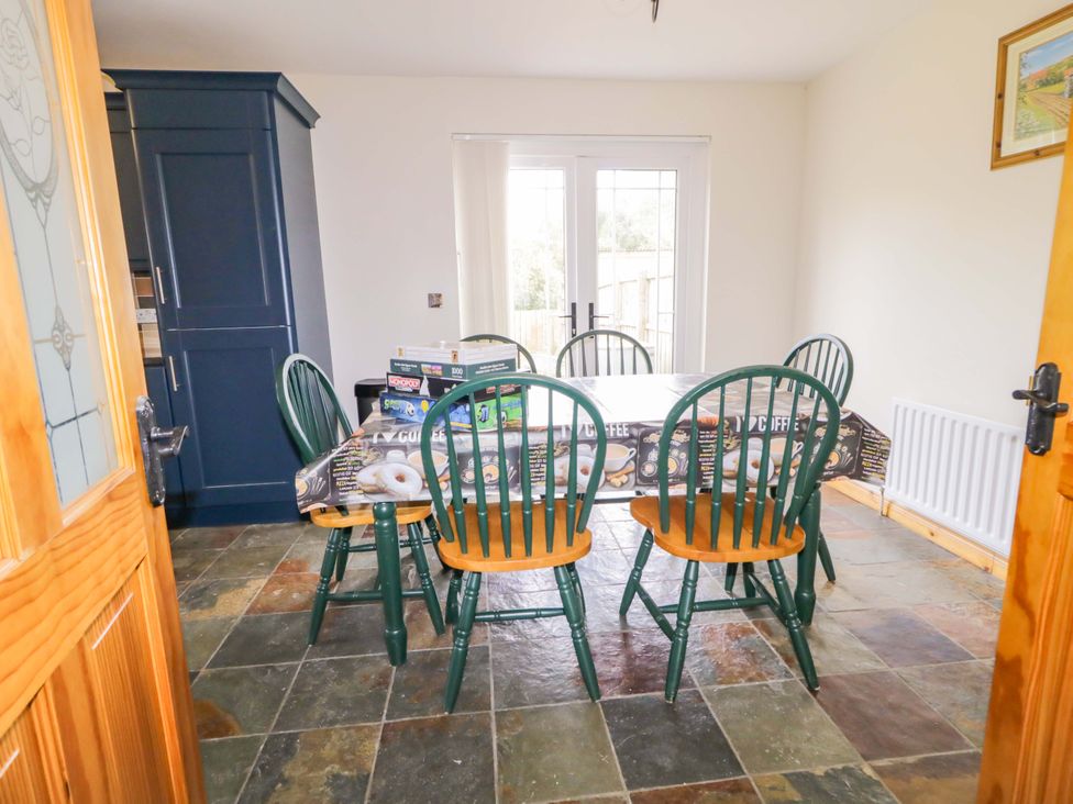 A dining room with a table and chairs at 7 Killybrack Glen in Omagh