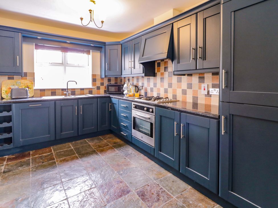 A kitchen with cabinets and appliances at 7 Killybrack Glen in Omagh