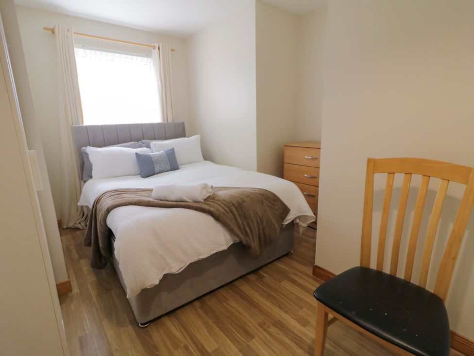 A bedroom with a bed and a chair at 7 Killybrack Glen Omagh