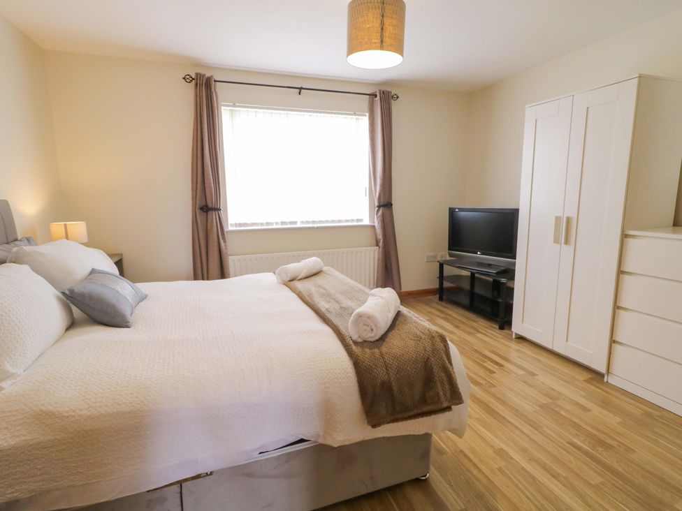 A bedroom with a bed and television at 7 Killybrack Glen in Omagh
