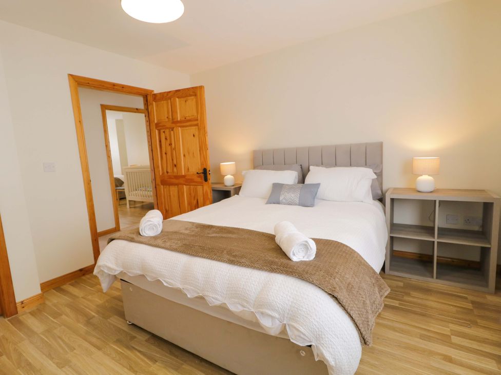 A bedroom with a bed and bedside tables at 7 Killybrack Glen in Omagh