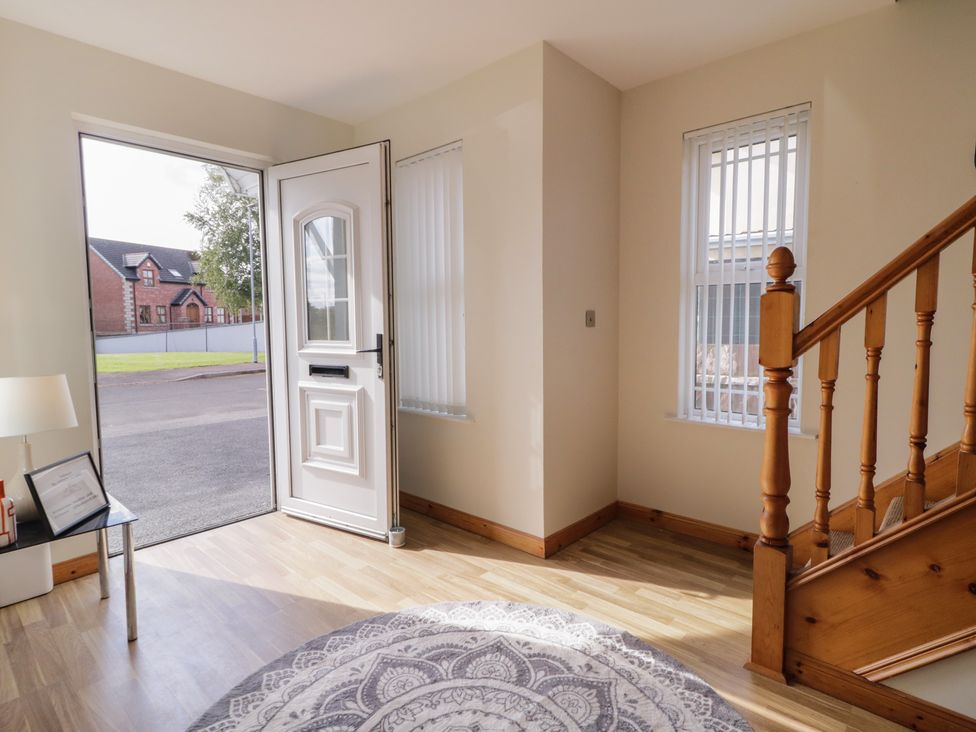 An entrance hall with a door open towards the street at The Sperrin Getaway in Omagh