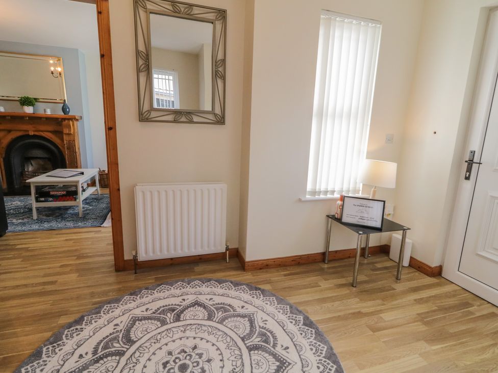 A hallway with a rug and a mirror at The Sperrin Getaway in Omagh