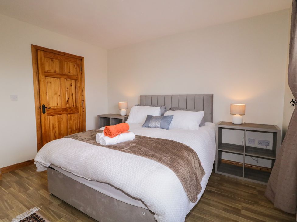 A bedroom with a bed and nightstands at The Sperrin Getaway in Omagh