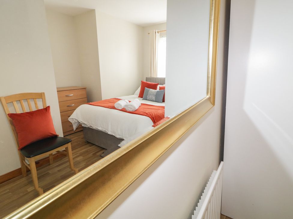 A bedroom with a bed and chair at The Sperrin Getaway in Omagh