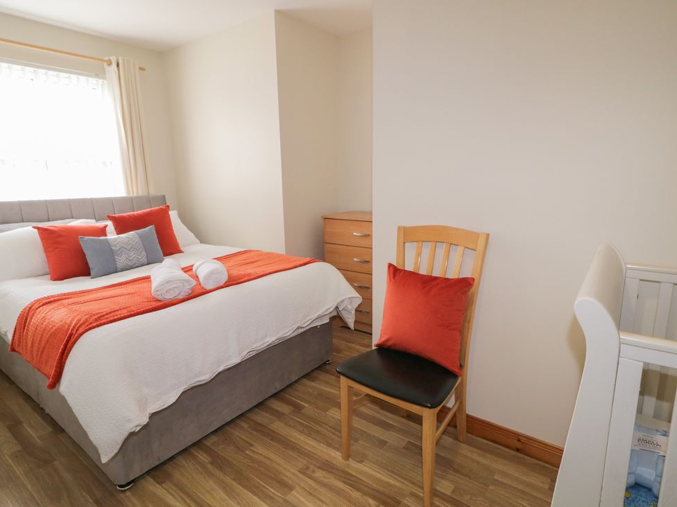 A bedroom with a bed and dresser at The Sperrin Getaway in Omagh