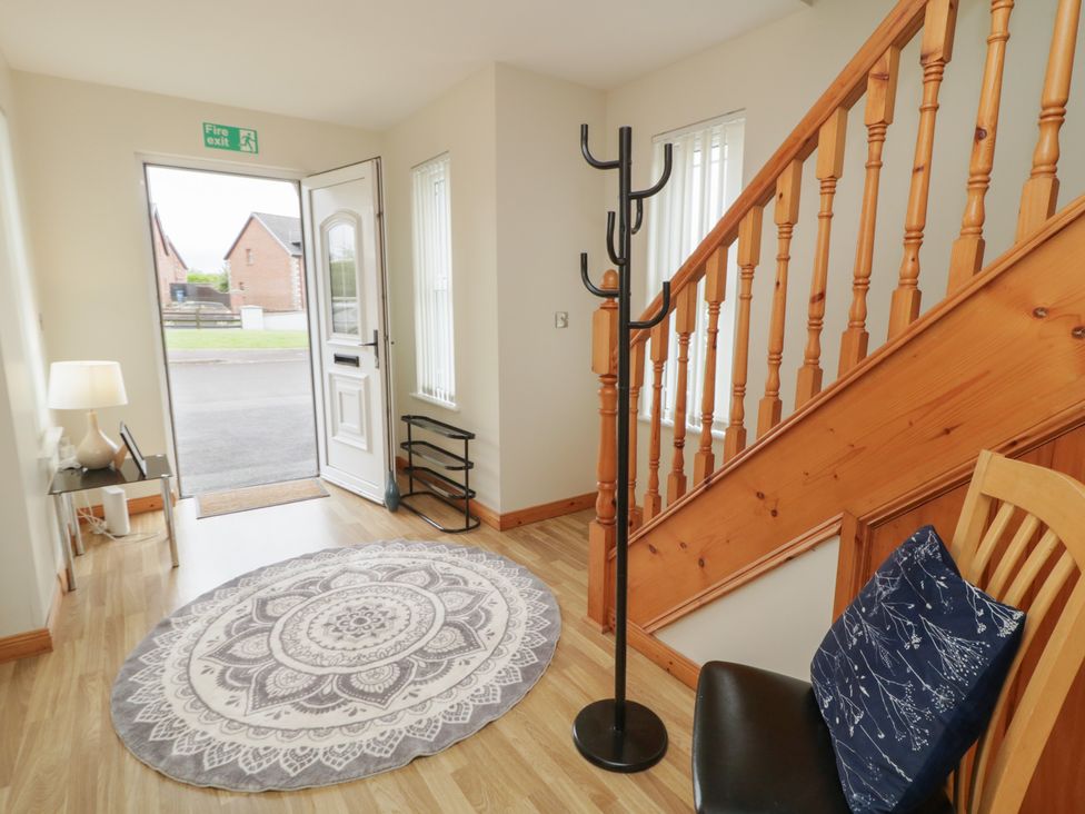 A hallway with a coat rack and a rug at The Sperrin Getaway in Omagh