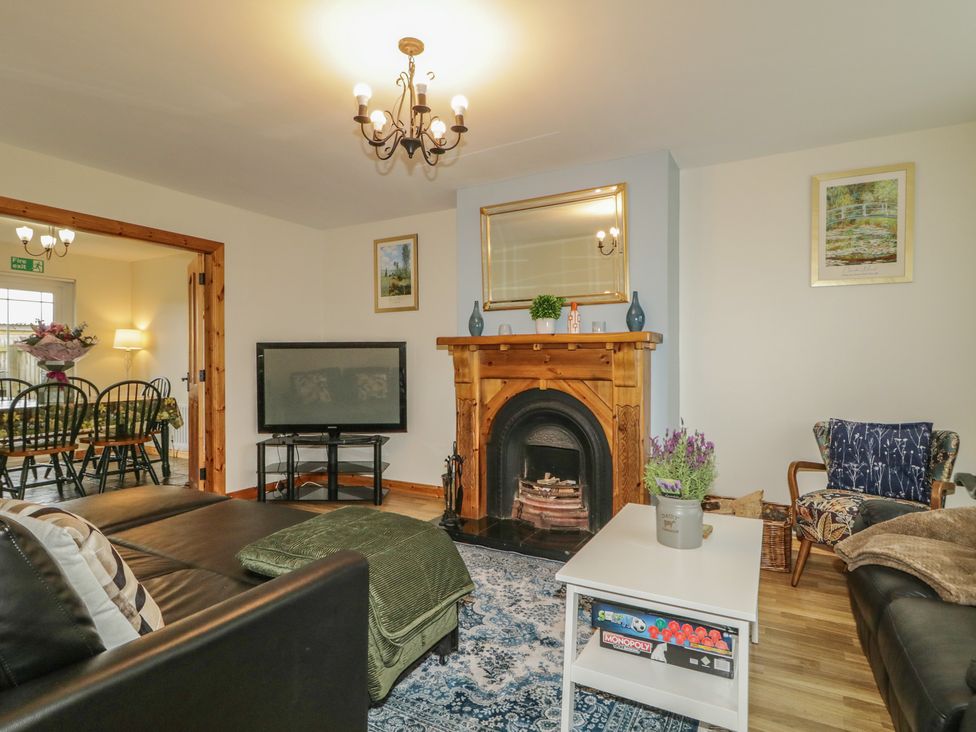 A living room with a sofa, coffee table, and fireplace at The Sperrin Getaway in Omagh