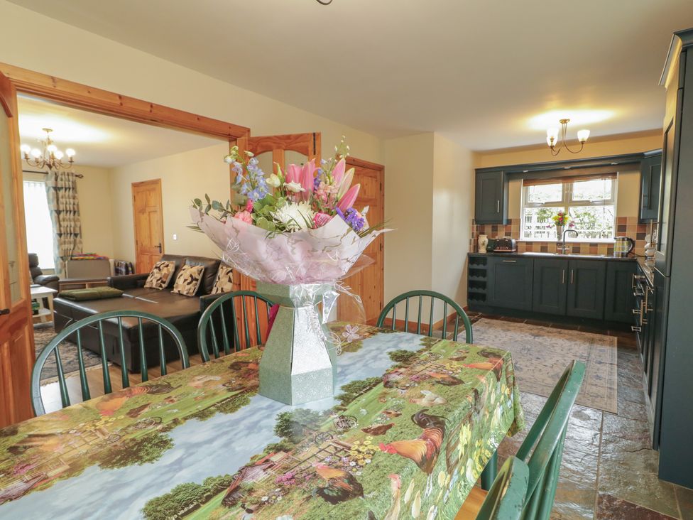 A dining room with a table and flowers at The Sperrin Getaway in Omagh