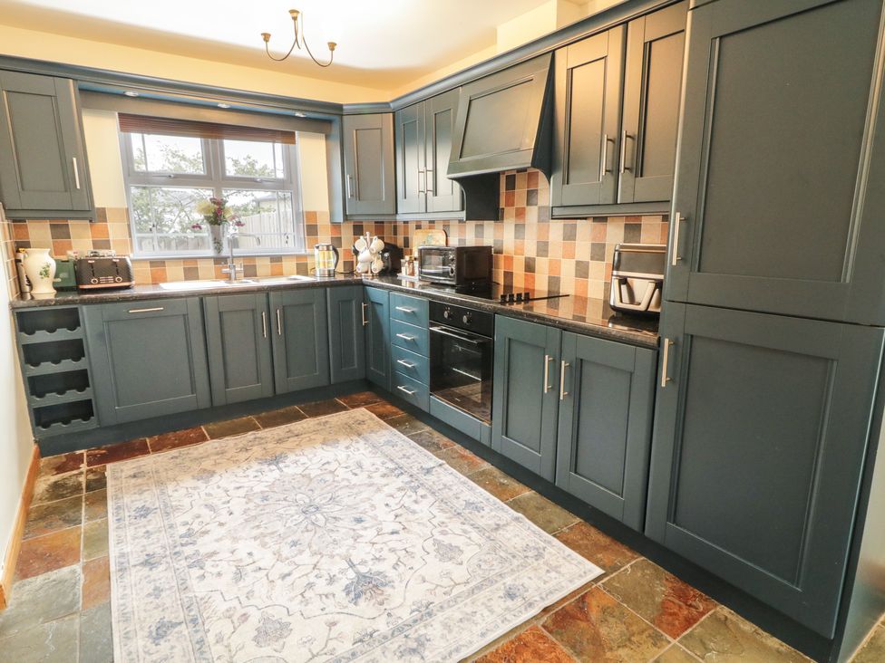 A kitchen with cabinets and a sink at The Sperrin Getaway in Omagh