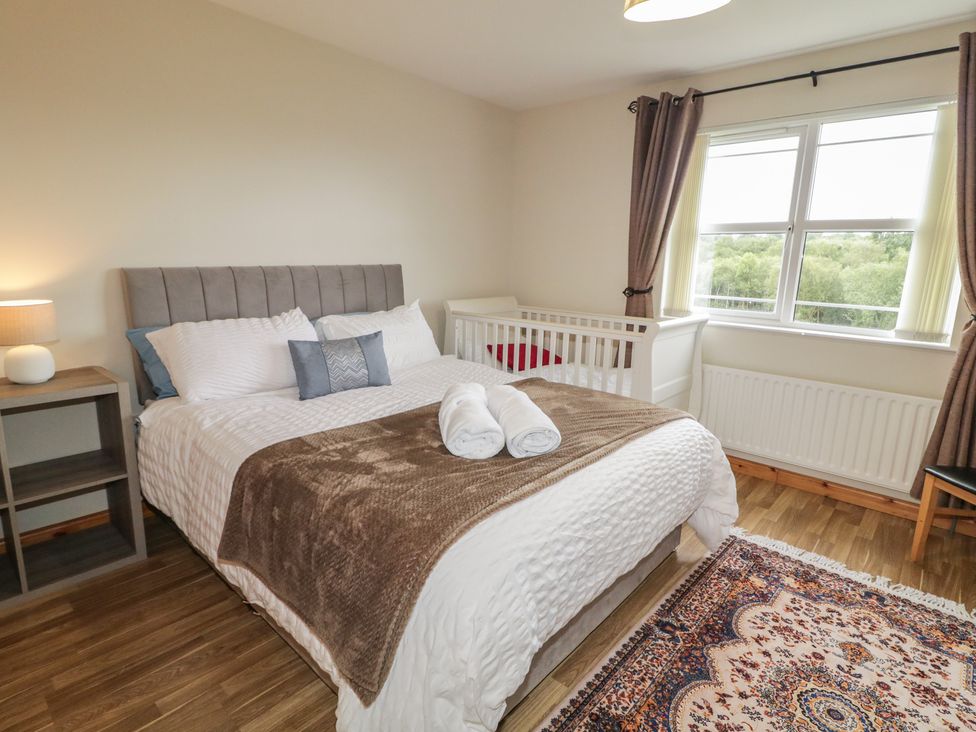 A bedroom with a bed and crib at The Sperrin Getaway in Omagh