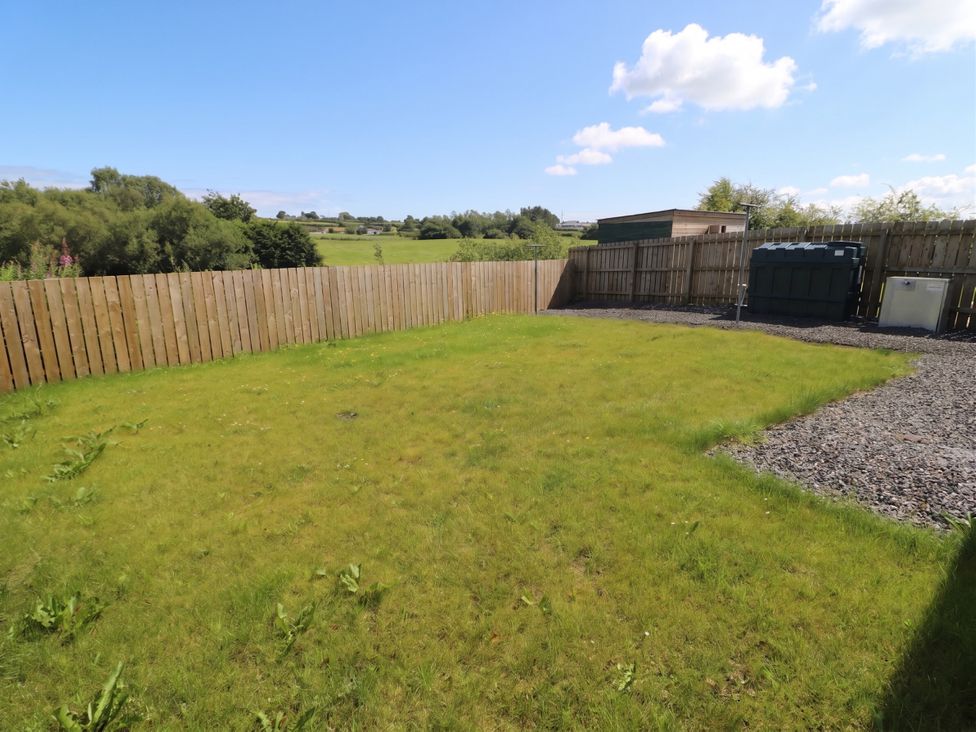 A garden with grass and gravel at The Sperrin Getaway in Omagh
