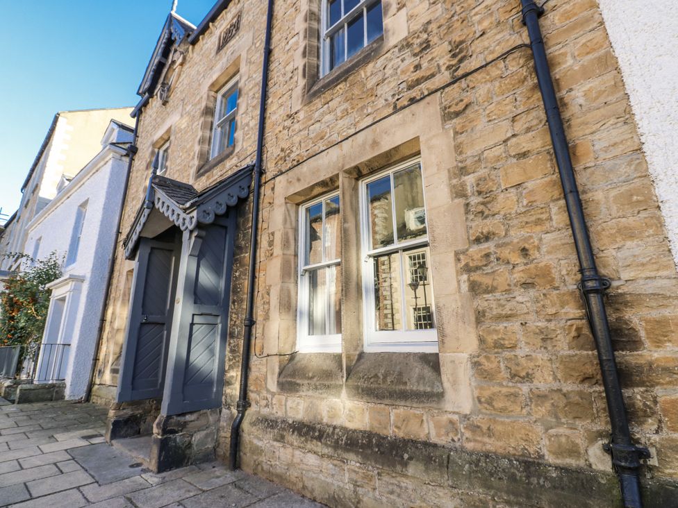 An exterior view of a stone building with windows and a front door at 26 Frenchgate Richmond
