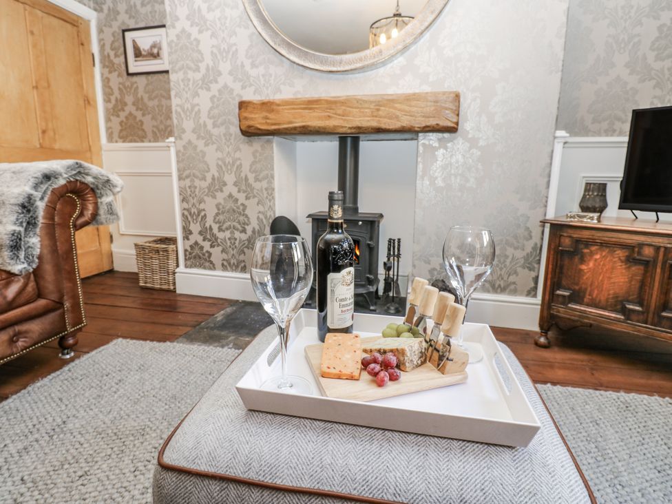 A living room with wine and cheese on a table at 26 Frenchgate in Richmond
