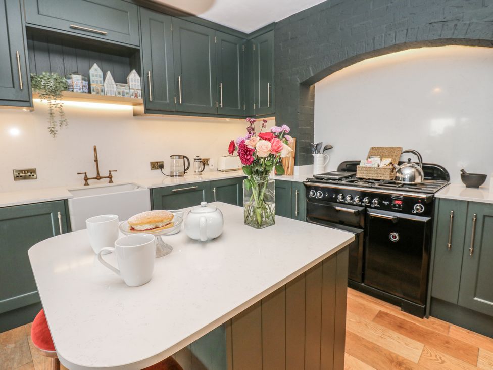 A kitchen with a table and flowers at 26 Frenchgate in Richmond