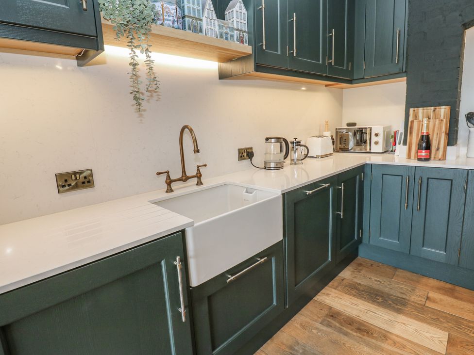 A kitchen with cabinets and appliances at 26 Frenchgate in Richmond