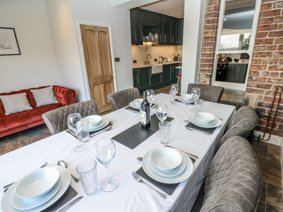 A dining room with a table set for dinner at 26 Frenchgate in Richmond