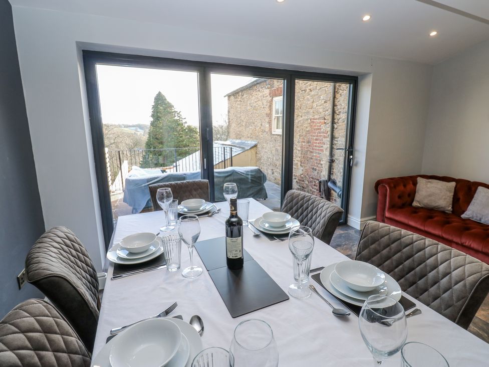 A dining room with a table set for a meal at 26 Frenchgate in Richmond