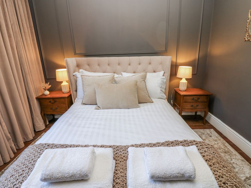 A bedroom with a bed and nightstands at 26 Frenchgate in Richmond