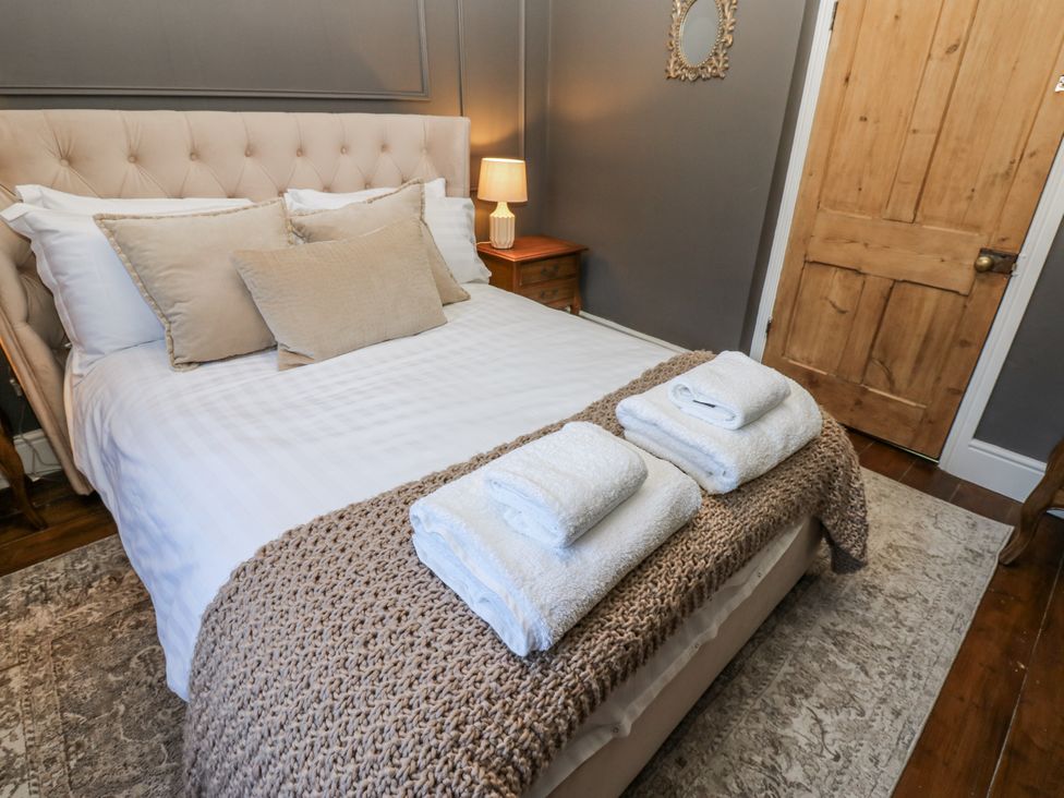 A bedroom with a bed and towels on it at 26 Frenchgate in Richmond