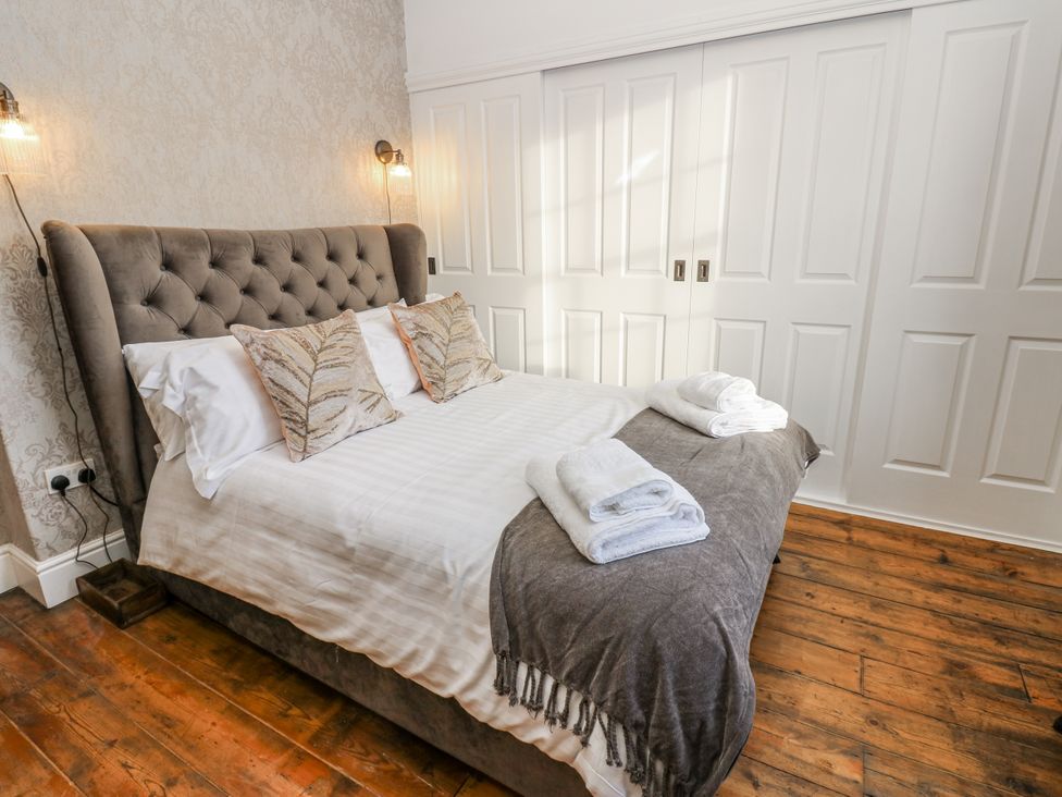 A bedroom with a bed and wardrobe at 26 Frenchgate in Richmond