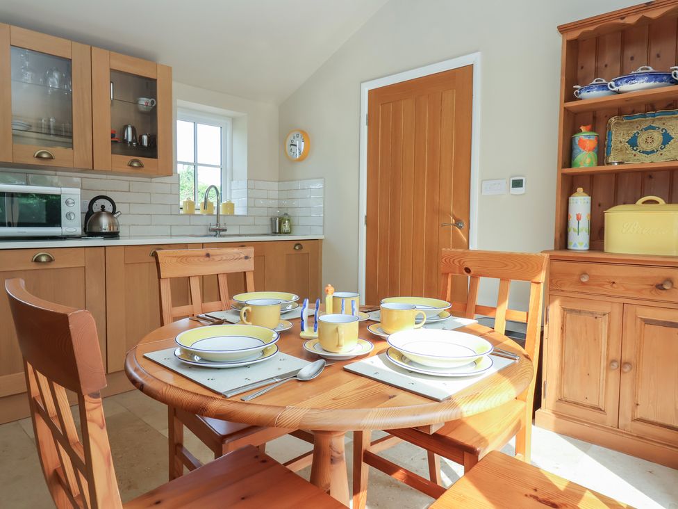 A kitchen with a dining table set at Apple Tree Cottage in York