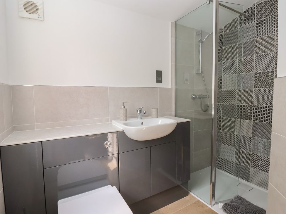 A bathroom with a sink and shower at Apple Tree Cottage in York