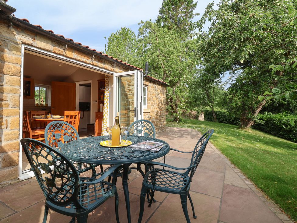An outdoor area with a table and chairs at Apple Tree Cottage in York