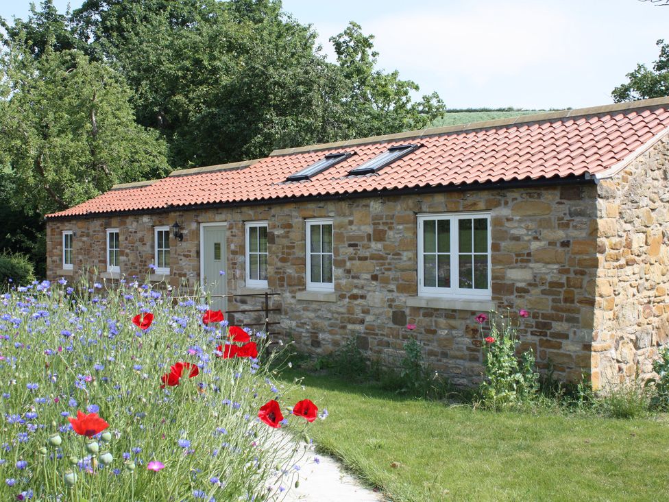 A cottage with windows and a garden at Apple Tree Cottage in York