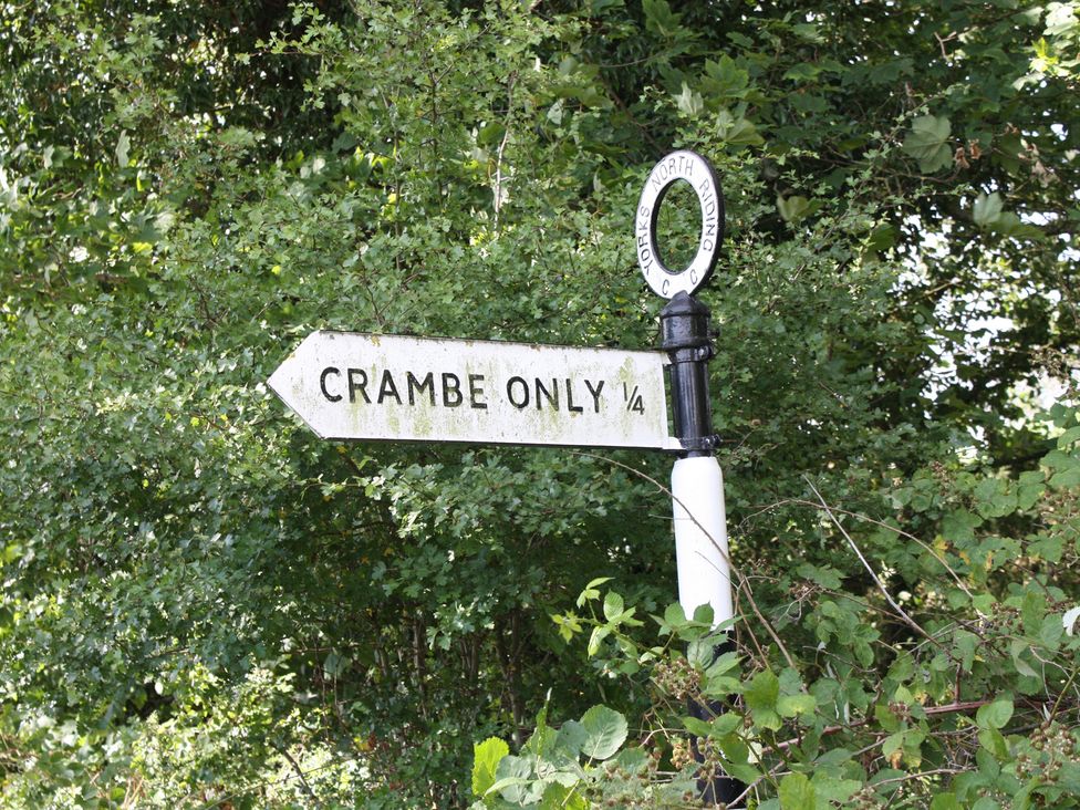 A directional sign indicating Cramby Only ¼ at Apple Tree Cottage in York