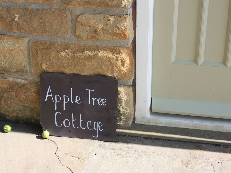 A sign for Apple Tree Cottage next to a door at Apple Tree Cottage in York