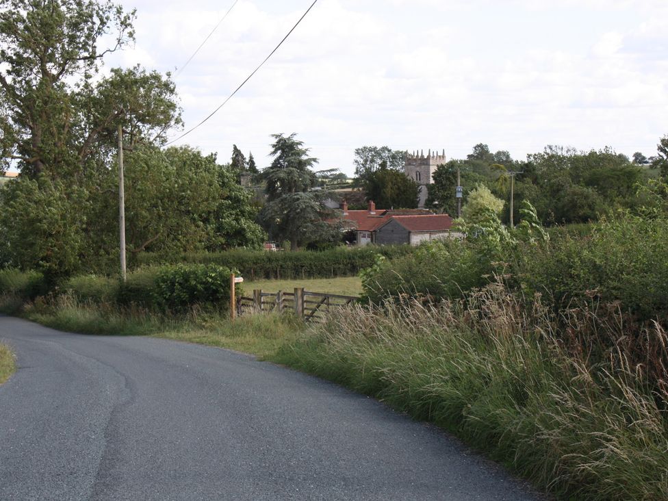 A view of a road with trees and buildings at Apple Tree Cottage in York